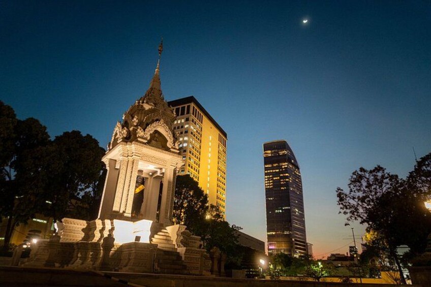 A night scene with a traditional temple and modern skyscrapers. 2