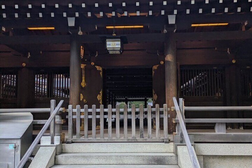 A staircase leading to a traditional building with wooden pillars and a white fence. 3