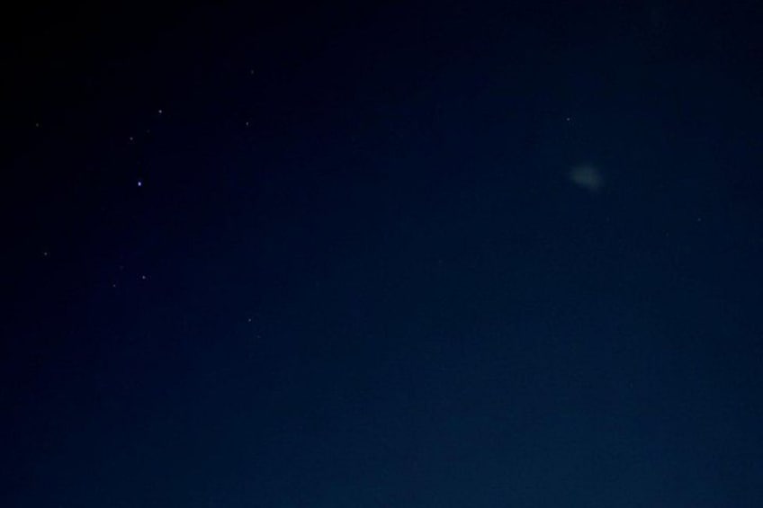 A night sky with stars and a faintly visible planet. 4