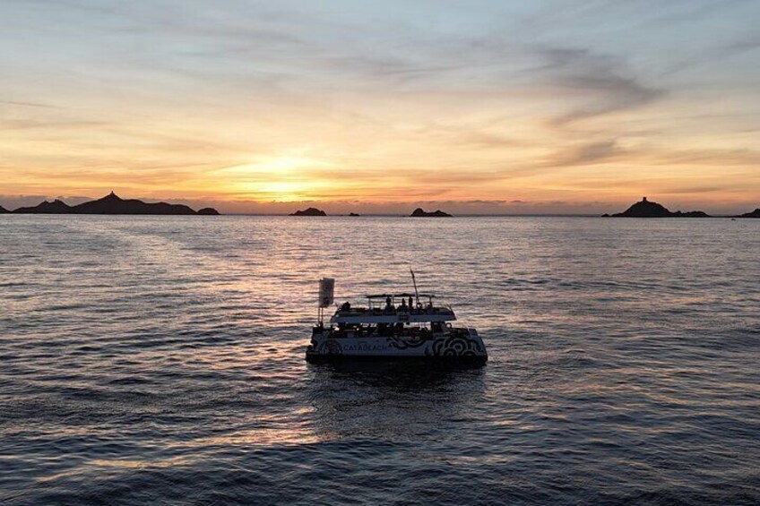 A boat on calm water during sunset with distant landforms. 5