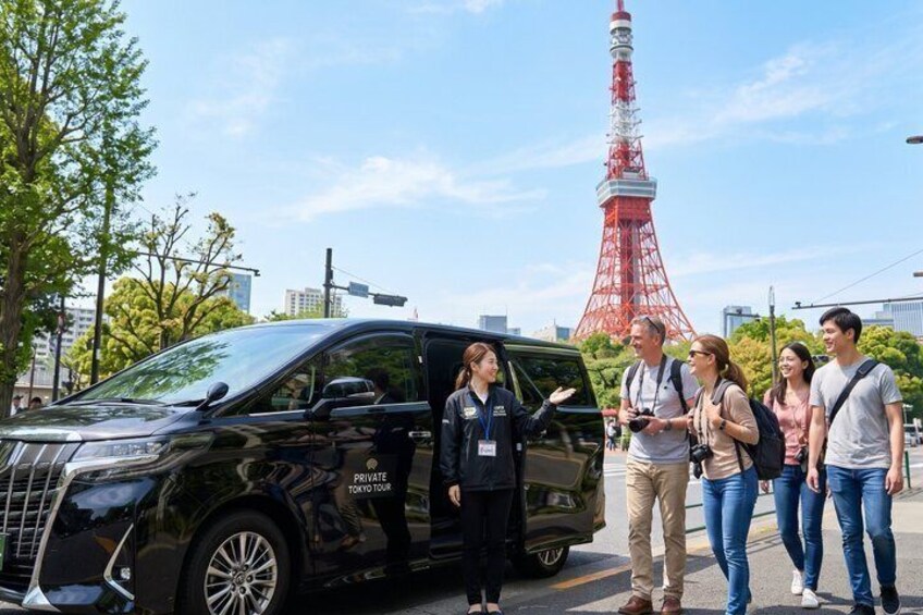 A black van with 'PRIVATE TOUR' on the side, a red and white tower in the background, and a group of people standing on the street. 1