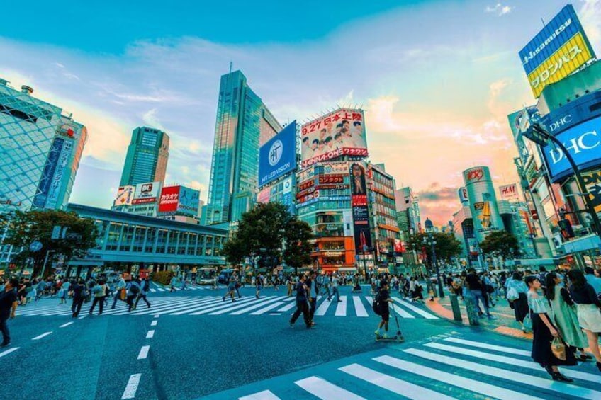 A busy urban intersection with tall buildings and pedestrians. 5