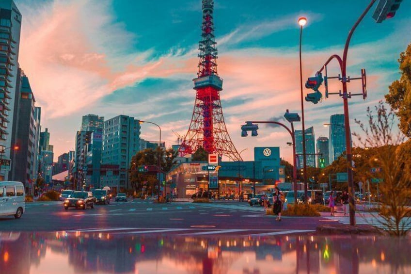 A cityscape with a prominent tower, buildings, and a reflection in a body of water. 3