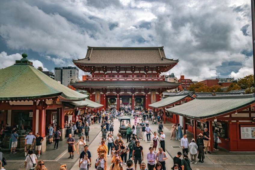 A traditional Japanese temple with a large crowd of people in front. 4