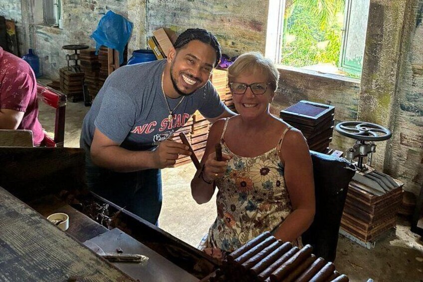Two people in a workshop with tools and wooden objects. 3