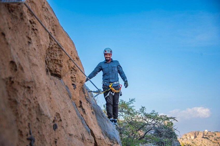 A person rappelling down a rocky cliff. 2