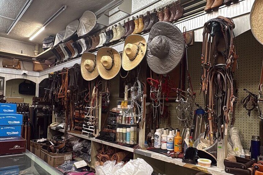 Una tienda con sombreros, zapatos y artículos de cuero a la vista. 5