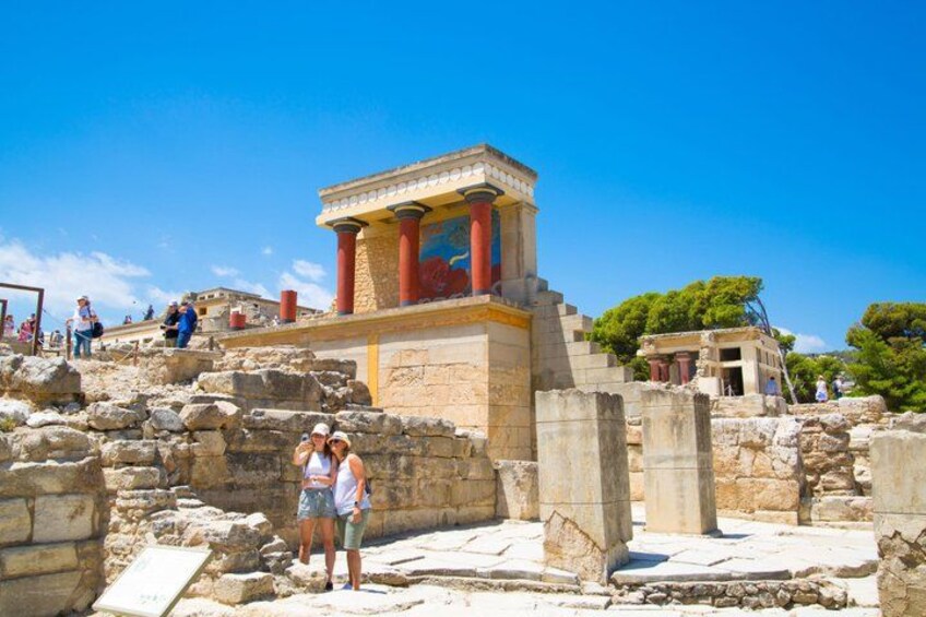 Ancient ruins with columns and a temple-like structure. 2