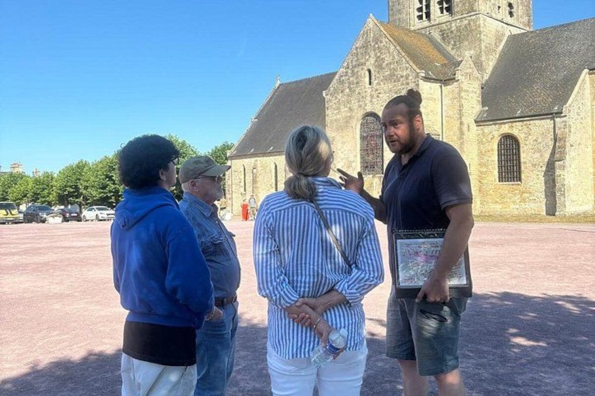 A group of people standing in front of a church with a clear blue sky. 5