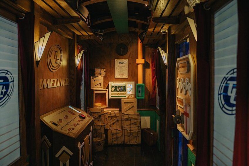 A control room with wooden walls, a control panel, and various technical equipment. 3