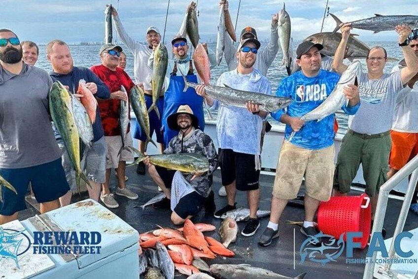 A group of people on a boat holding fish. 5