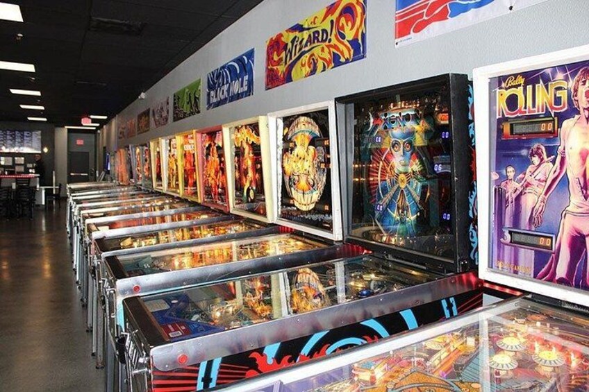 Una hilera de máquinas de pinball en una sala de juegos. 4