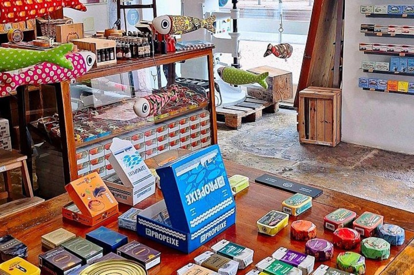 A room with a display of colorful dice, a fish-shaped decoration, and various boxes and items on shelves. 5