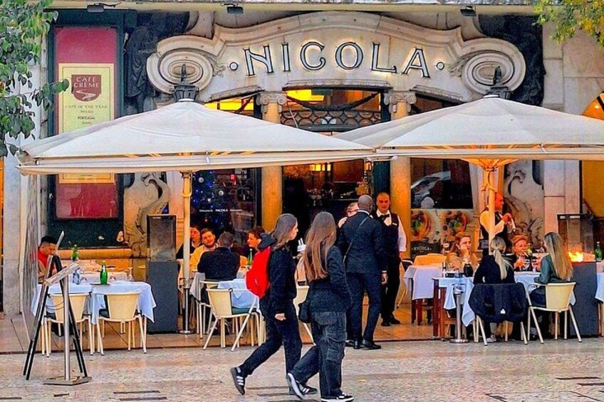 A restaurant named 'NIGOLA' with outdoor seating and patrons dining. 4