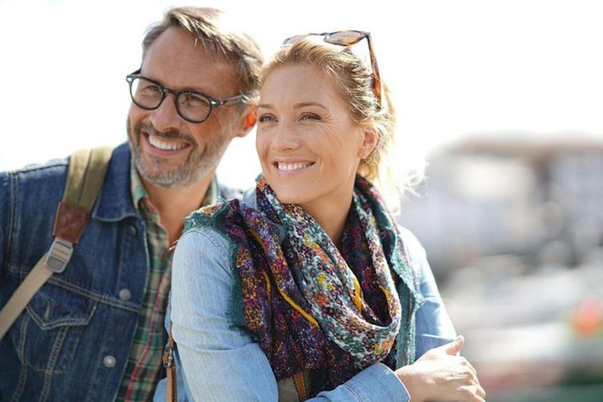 A person wearing a denim jacket and a colorful scarf. 4