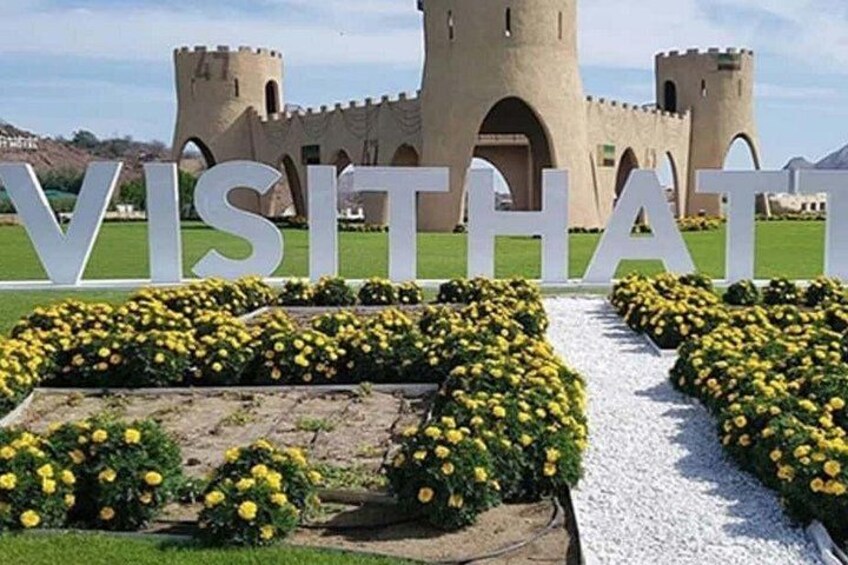 A castle with a sign reading 'VISIT THAT' in front. 5