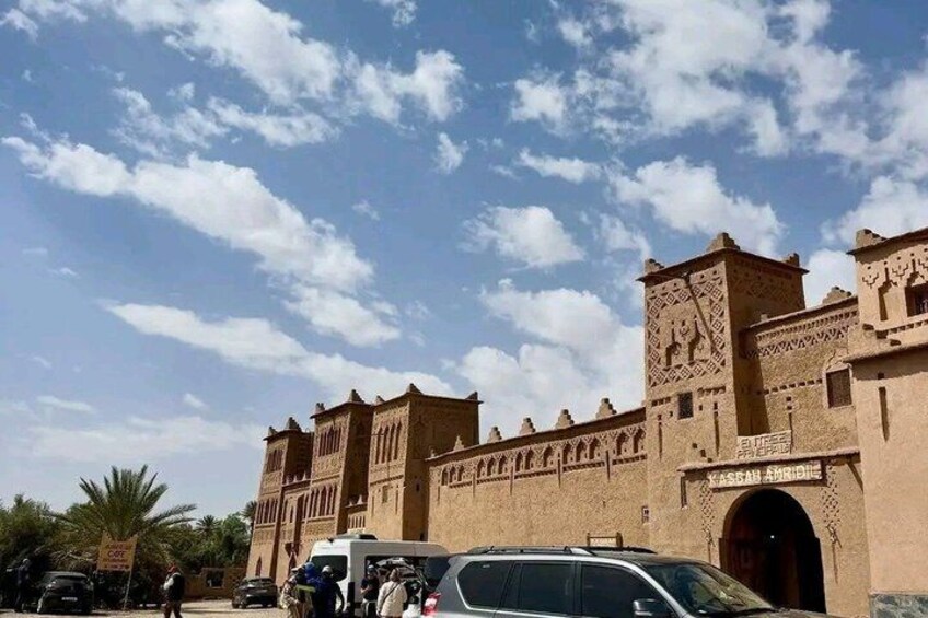 A historic building with intricate carvings and a clear blue sky. 2