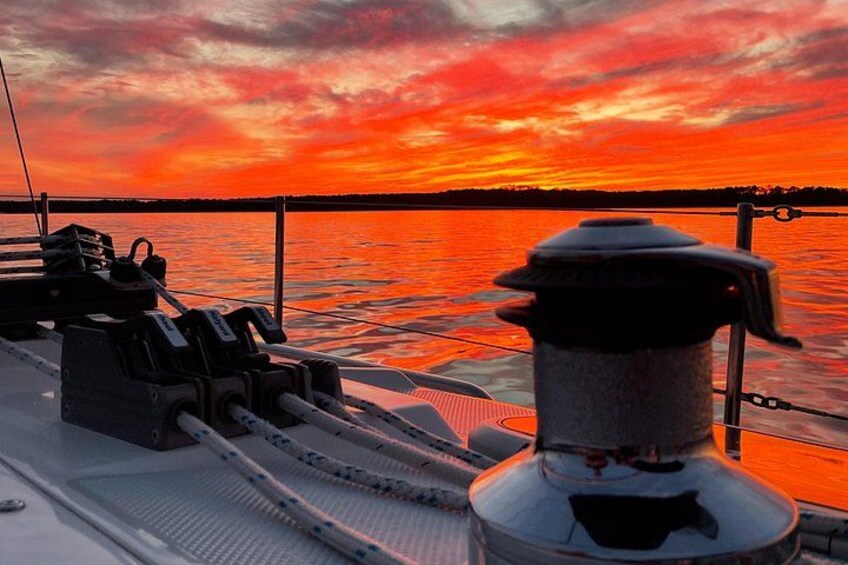 Un pont de bateau offrant une vue sur un coucher de soleil sur l’eau. 5