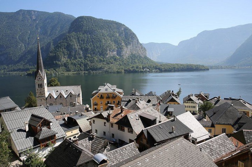 A town with buildings, a church, and mountains in the background. 1