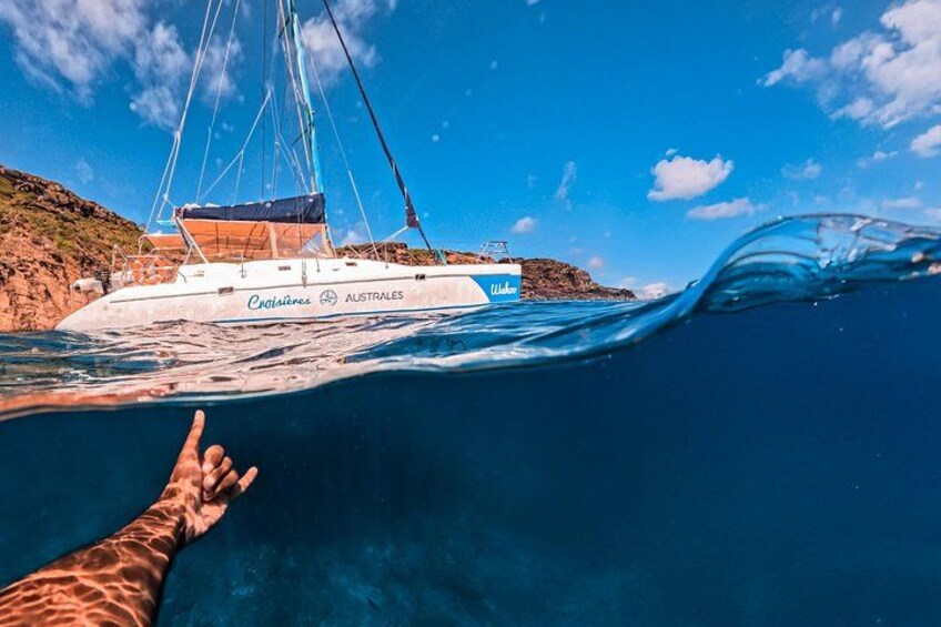 A sailboat named 'Australes' with a person reaching out towards it. 5