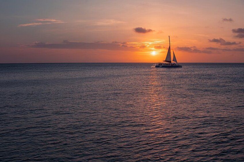 A sailboat on calm waters during sunset. 2