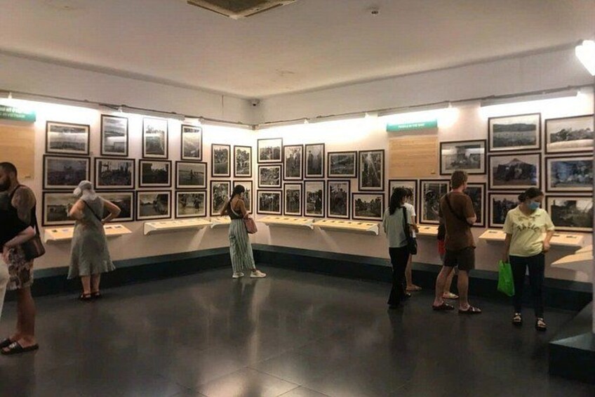 An indoor art gallery with framed photographs on display. 2
