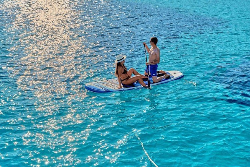 Two people on paddleboards in a calm body of water. 5