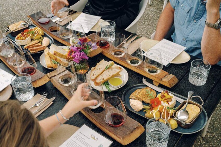 A table set with various dishes, glasses of wine, and a menu. 5