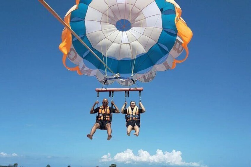 Two people skydiving with a parachute. 1