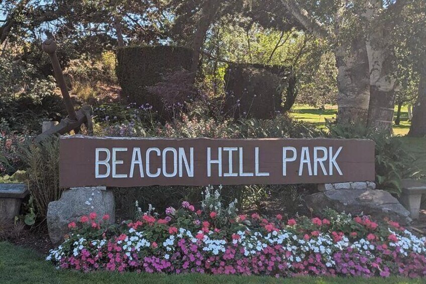 A sign for Beacon Hill Park surrounded by colorful flowers. 2
