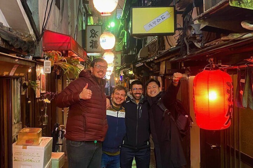 A narrow alley with shops, a red lantern, and signs in Japanese. 1
