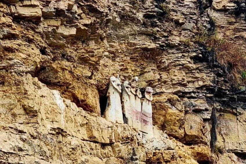 A rocky cliff with carved figures. 3