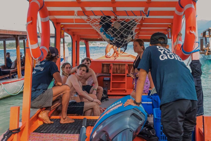 A group of people on a boat with life jackets and a Yamaha outboard motor. 5