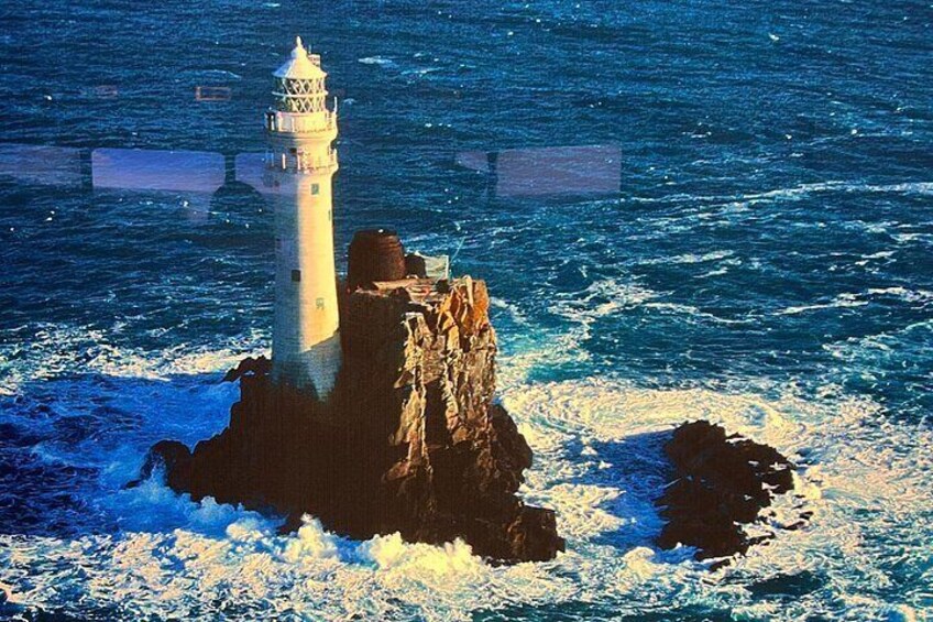 A lighthouse on a rocky outcrop surrounded by ocean waves. 3