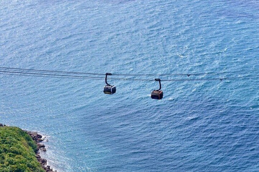 Two cable cars suspended over a body of water. 3