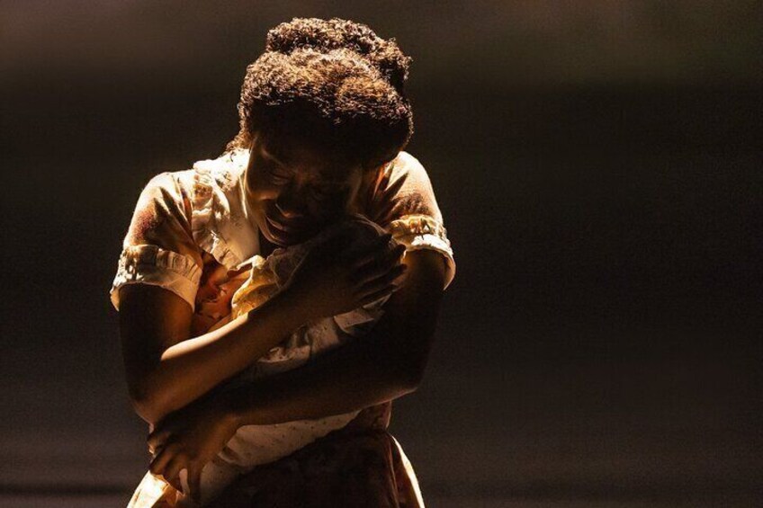 A person embracing another person in a dimly lit setting. 4
