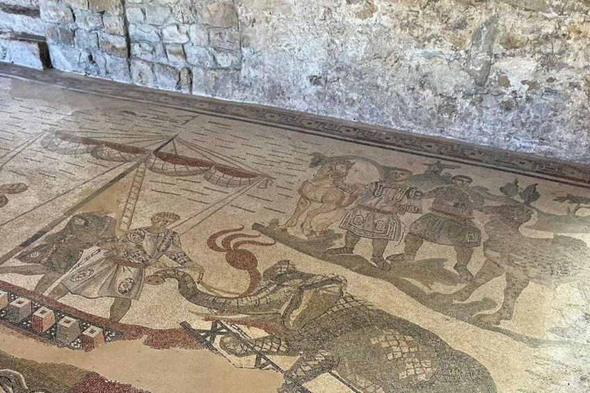 Ein Mosaik mit Reitern, einem Wagen und einem Schild. 3