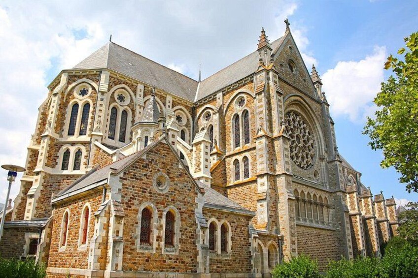 A large, historic church with intricate architecture, including arched windows and a prominent circular stained glass window. 2