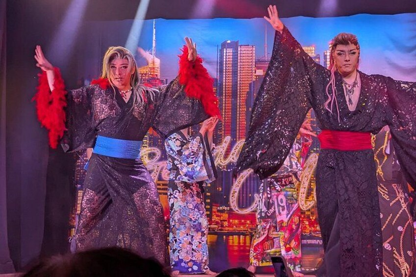 Performers in traditional costumes with a cityscape backdrop. 4