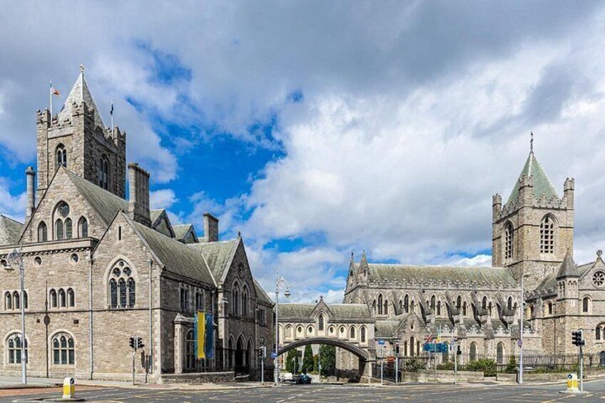 A historic stone building with multiple towers and arched windows. 4