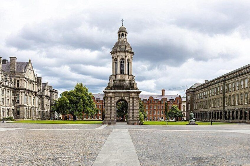 A historic building with a central tower, a cobblestone plaza, and classical architecture. 3