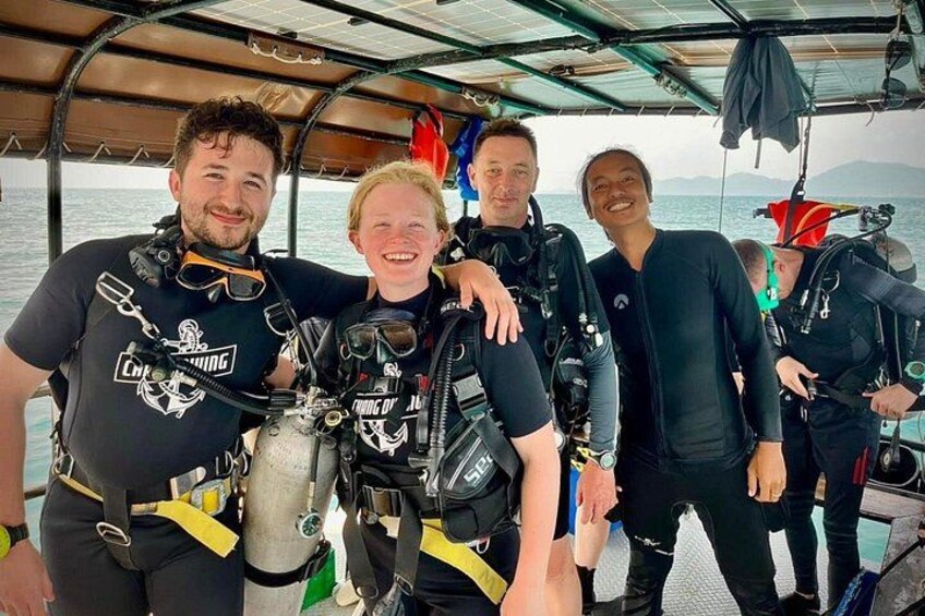 A group of people on a boat wearing scuba diving gear. 2