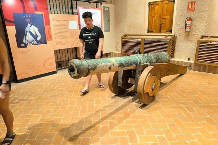 A historical cannon in a museum setting. 1