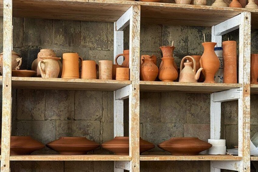 Shelves with various clay pottery items. 5