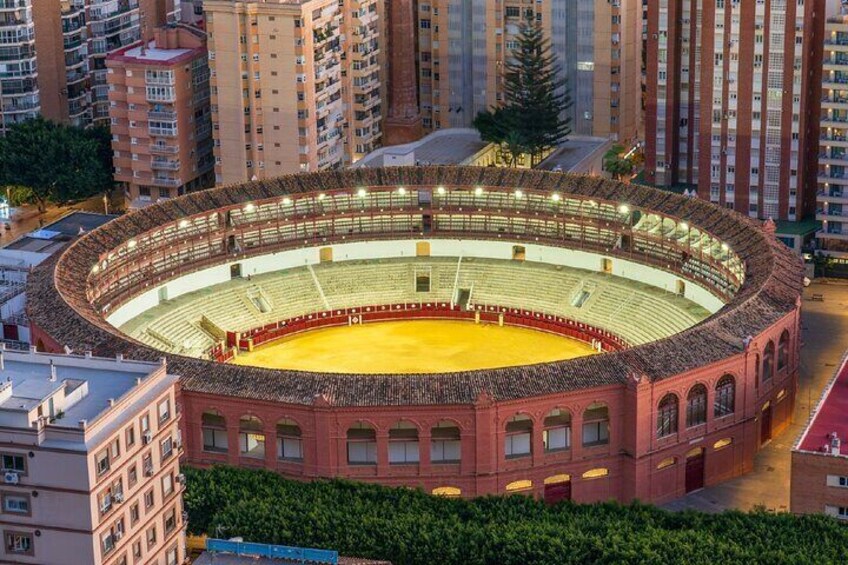 A bullring surrounded by high-rise buildings. 2