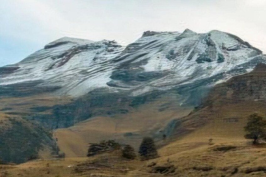 A snow-capped mountain range with a valley in the foreground. 3