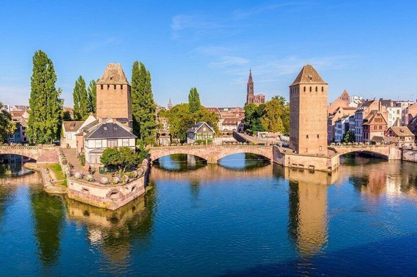 A river with bridges, towers, and historic buildings. 3