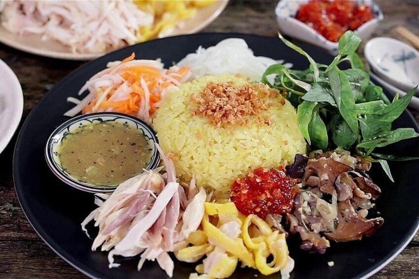 A plate of food with rice, vegetables, and meat. 2