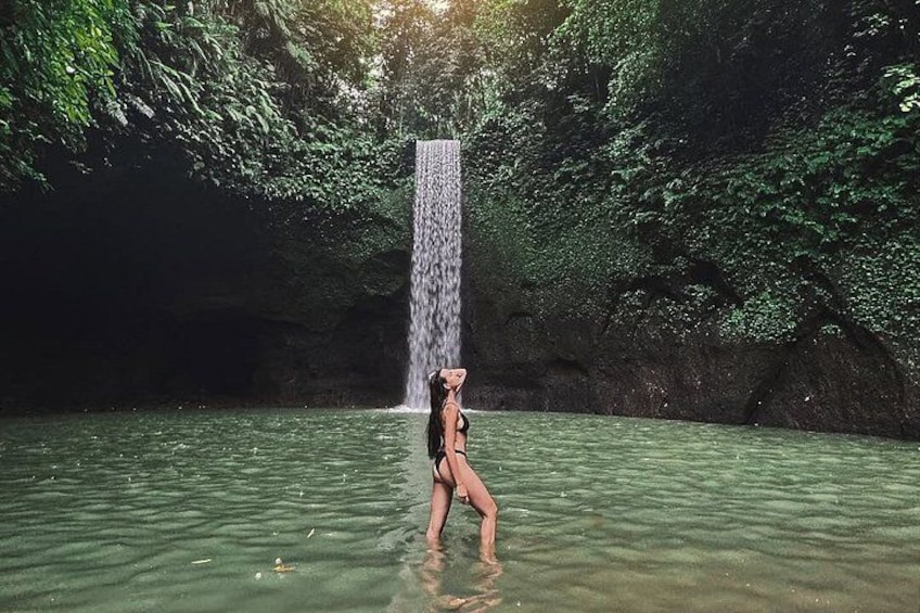 A waterfall in a forested area with clear water. 3