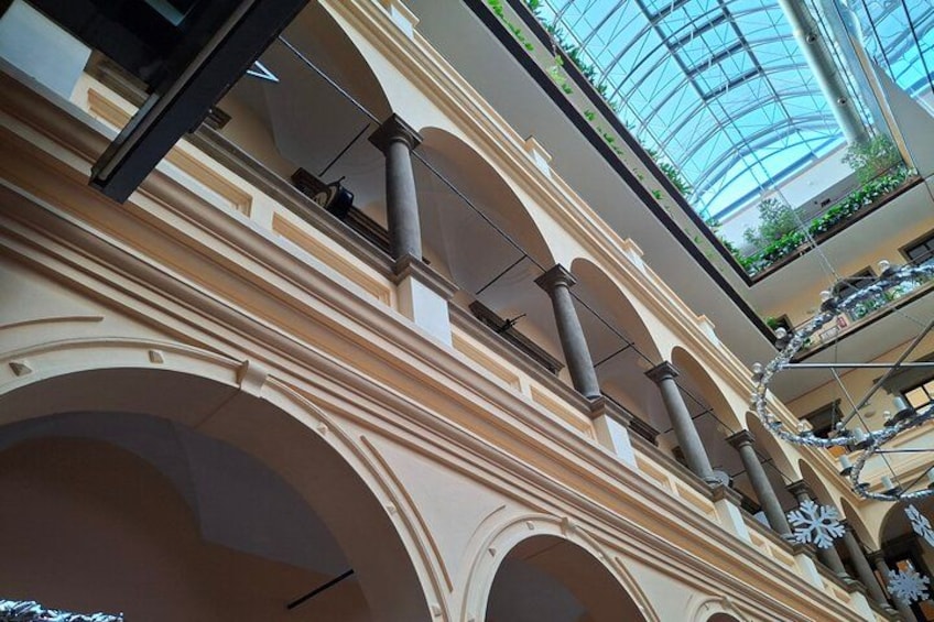 An interior with arched ceilings, columns, and a glass dome. 2